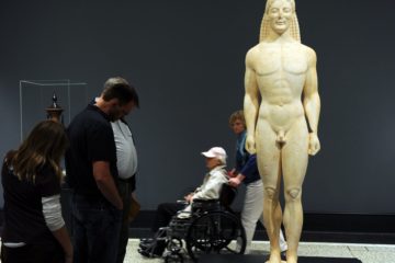 Visitors look at a Marble statue of a Kouros, representing the Greek physical ideal during the Archaic period (700-480 BC), at the Getty Villa Museum in Malibu, California on April 18, 2011. The Getty Villa exhibits classical antiquities collection of Greek, Roman and Etruscan art. The Villa is modeled after a Roman country house buried by the eruption of Mt. Vesuvius in 79 AD.       AFP PHOTO / GABRIEL BOUYS (Photo credit should read GABRIEL BOUYS/AFP/Getty Images)