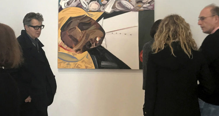 A group of museum-goers examine a painting entitled "Open Casket" by artist Dana Schutz at the Whitney Museum of American Art in New York, Thursday, March 23, 3017. The painting, made with the aid of historical photographs of Emmett Till as he lay in his casket, has left some gravely displeased and triggered outcry. Till was a 14-year-old black teenager when he was killed by white men in 1955 for allegedly whistling at a white woman. (AP Photo/Alina Heineke)