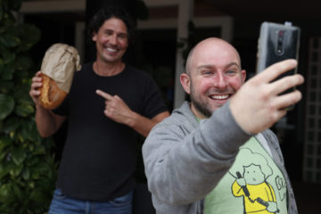 SYDNEY, AUSTRALIA - APRIL 08: Colin Fassnidge has a selfie with a fan at the Banksia Hotel on April 08, 2020 in Sydney, Australia. Colin Fassnidge is distributing donated food from local producers to those in need from the carpark of the Banksia Hotel, where the bistro he normally cooks at is shut due to COVID-19. (Photo by Don Arnold/Getty Images)