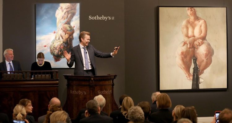 LONDON, ENGLAND - OCTOBER 05: Oliver Barker, Chairman of Sotheby's Europe, fields bids for Jenny Saville’s 1992 painting 'Propped', the work that propelled her to international acclaim at Sotheby's Contemporary Art Evening Auction at Sotheby's on October 5, 2018 in London, England. The painting sold tonight at Sotheby’s in London for £9.5m / $12.4 million / €10.8 million, setting a new auction record for a work by a living female artist. The painting was part of the collection of David Teiger, visionary collector and patron of the arts. Proceeds from this and from other works from his collection will benefit the Teiger Foundation, soon to be one of the world’s largest and most significant contemporary art foundations. (Photo by Tristan Fewings/Getty Images for Sotheby's) *** Local Caption *** Oliver Barker