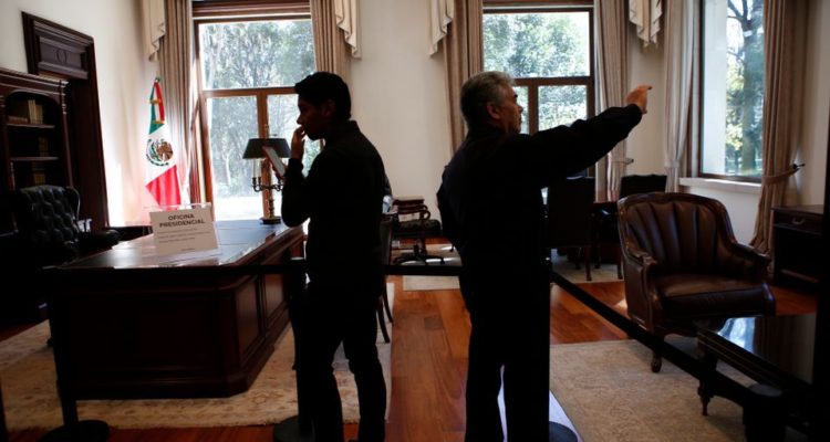 Visitors take photos inside the presidential office at the presidential residence know as Los Pinos in Mexico City, Saturday, Dec. 1, 2018. Inside the compound, successive presidents had built several homes, ranging from palatial to casual. There are unmistakeable signs of luxury: there was marble, art works on the walls, room-sized closets and wood-paneled libraries and offices. There was a small cinema in the basement of one building. (AP Photo/Ginnette Riquelme)