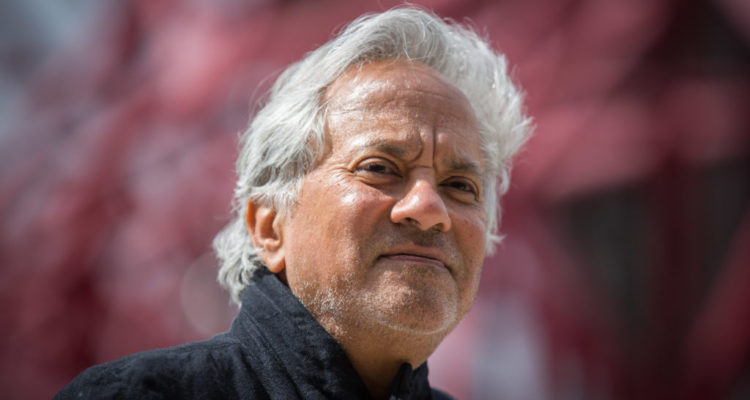 LONDON, ENGLAND - APRIL 26: Anish Kapoor poses for photographers in front of the ArcelorMittal Orbit tower at the Queen Elizabeth Olympic Park on April 26, 2016 in London, England. Tickets for The Slide, the world's tallest and longest tunnel slide, created by artists Anish Kapoor and Carsten Holler went on sale today. The 178 metre slide from the top of the ArcelorMittal Orbit, which will open on June 24, takes 12 turns with riders expected to reach 15 miles per hour before reaching the ground. (Photo by Rob Stothard/Getty Images)